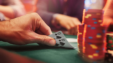 showing your poker hand with a stack of chips