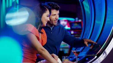 couple playing on a slot machine