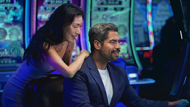 couple playing at a slot machine