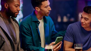 Group of guys talking at a sports bar